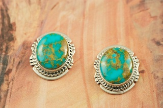 Genuine Turquoise Mountain Mine Turquoise set in Sterling Silver Post Earrings. The Turquoise Mountain Mine is located in the Mineral Park Mining District, Mohave County, Arizona. Although Turquoise Mountain is located near the Kingman Turquoise Mine it is considered a classic mine in its own right because the Turquoise is so different in appearance. It is also known as 